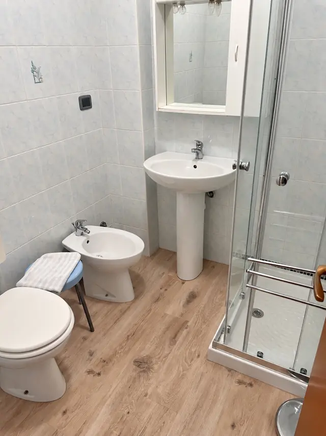 Bagno con lo specchio, il lavabo e la doccia